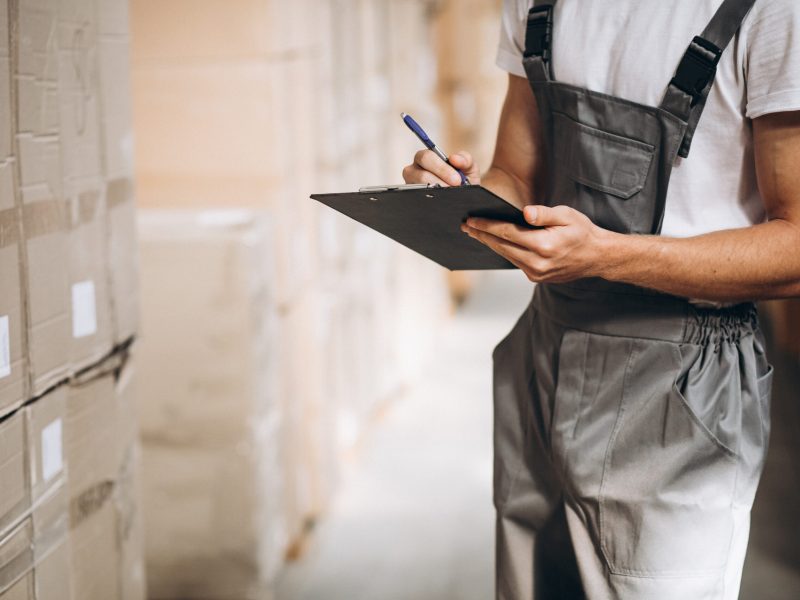 Young man working at a warehouse with boxes